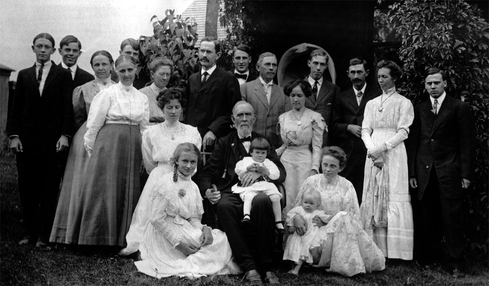 Photograph of Joseph Sinton in Colorado Springs, USA on his 90th birthday surrounded by three generation of descendants.